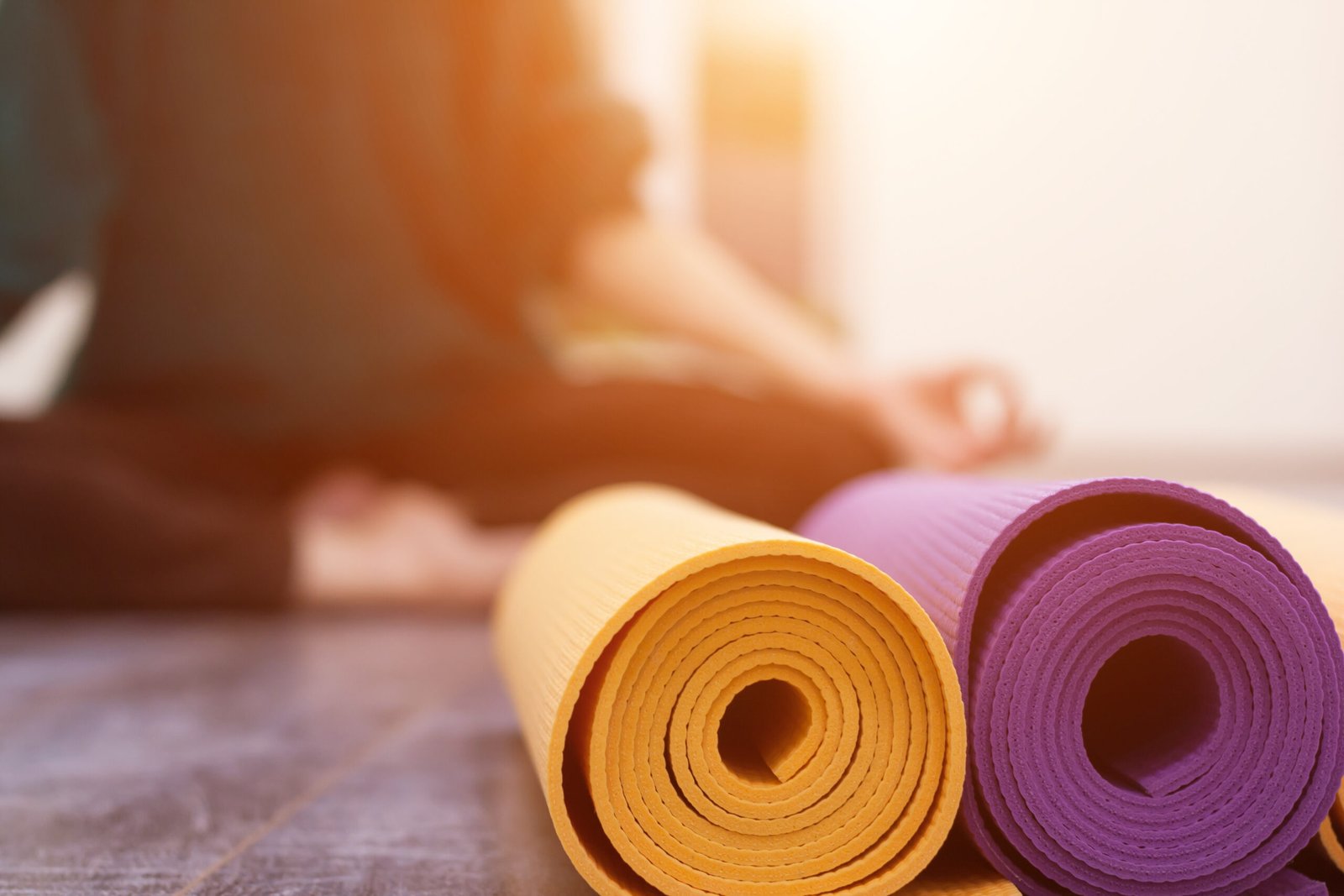 Closeup view of yoga mat and woman on background